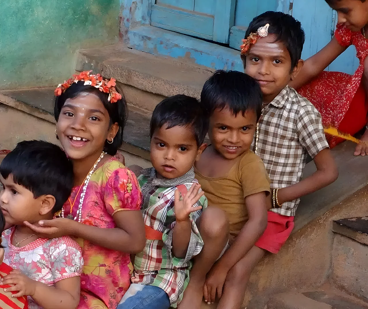 Children smiling on a doorstep