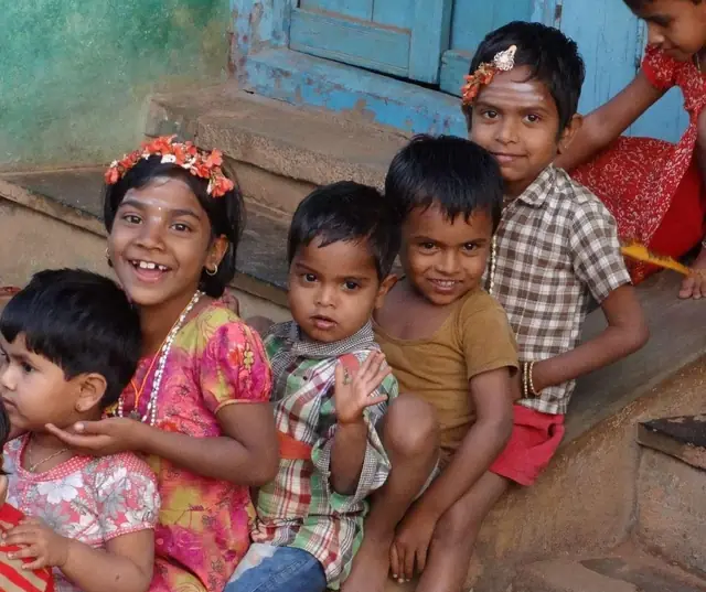 Children smiling on a doorstep